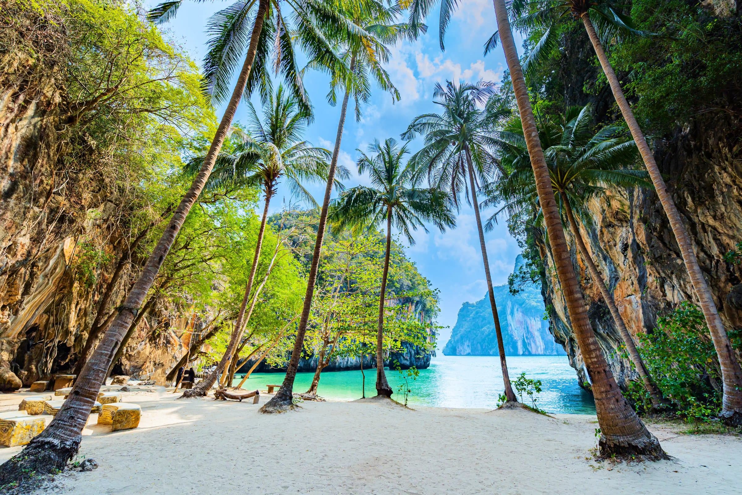 Turquoise water and white sand at Koh Hong, seen through coconut palms