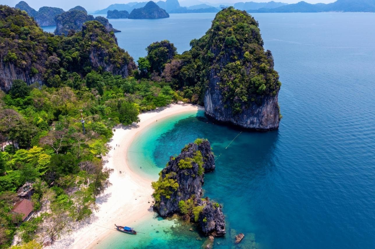 Koh Hong from above: a white beach between limestone cliffs and deep blue sea