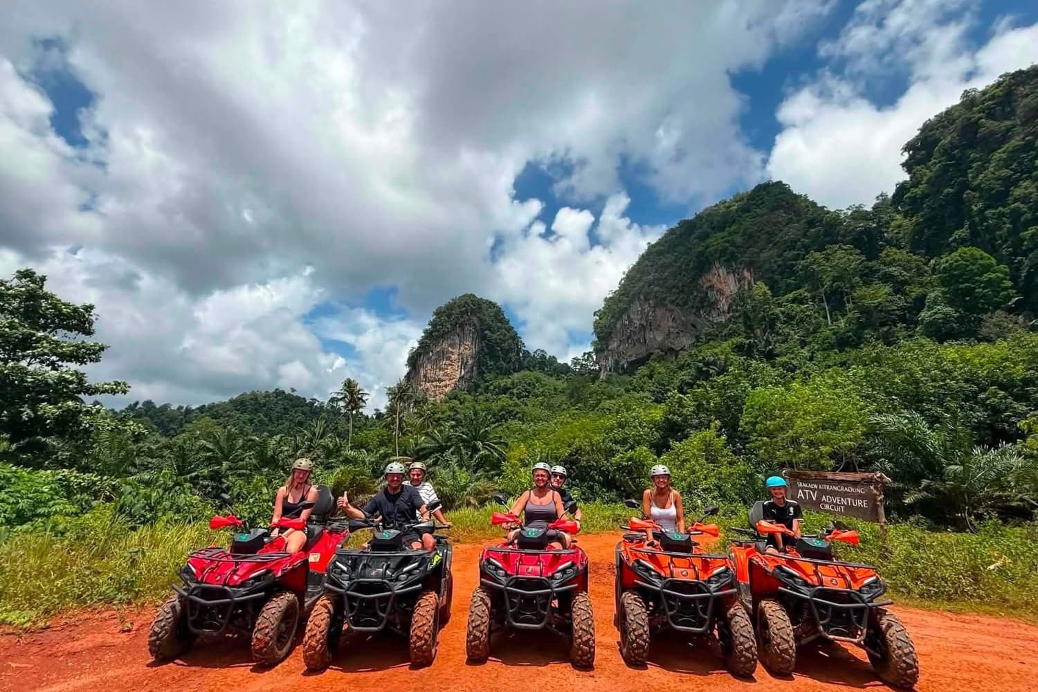 Five quads lined up at the ATV circuit under the limestone
