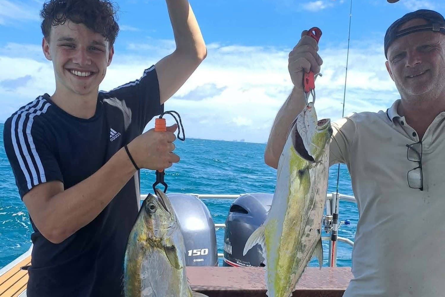 Two guests with golden trevally caught offshore