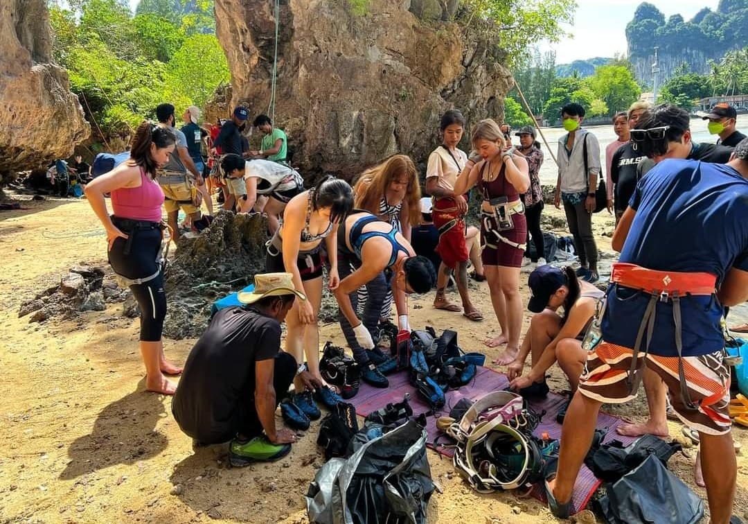 Getting fitted with shoes and harnesses on the beach