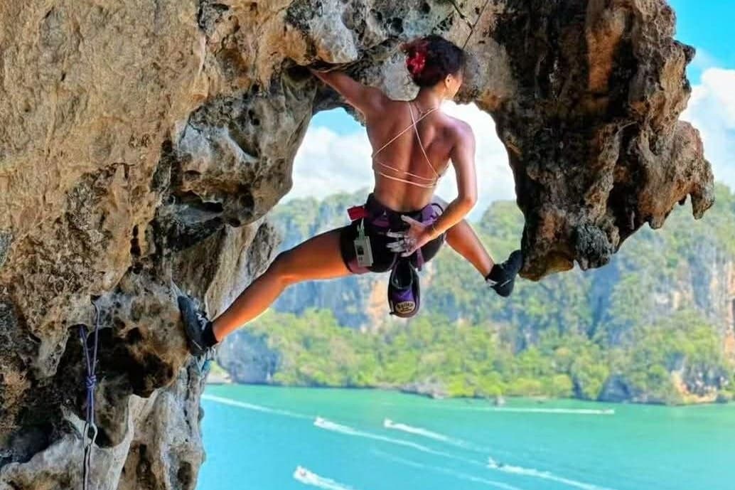 Lead climbing an overhang above the sea at Railay