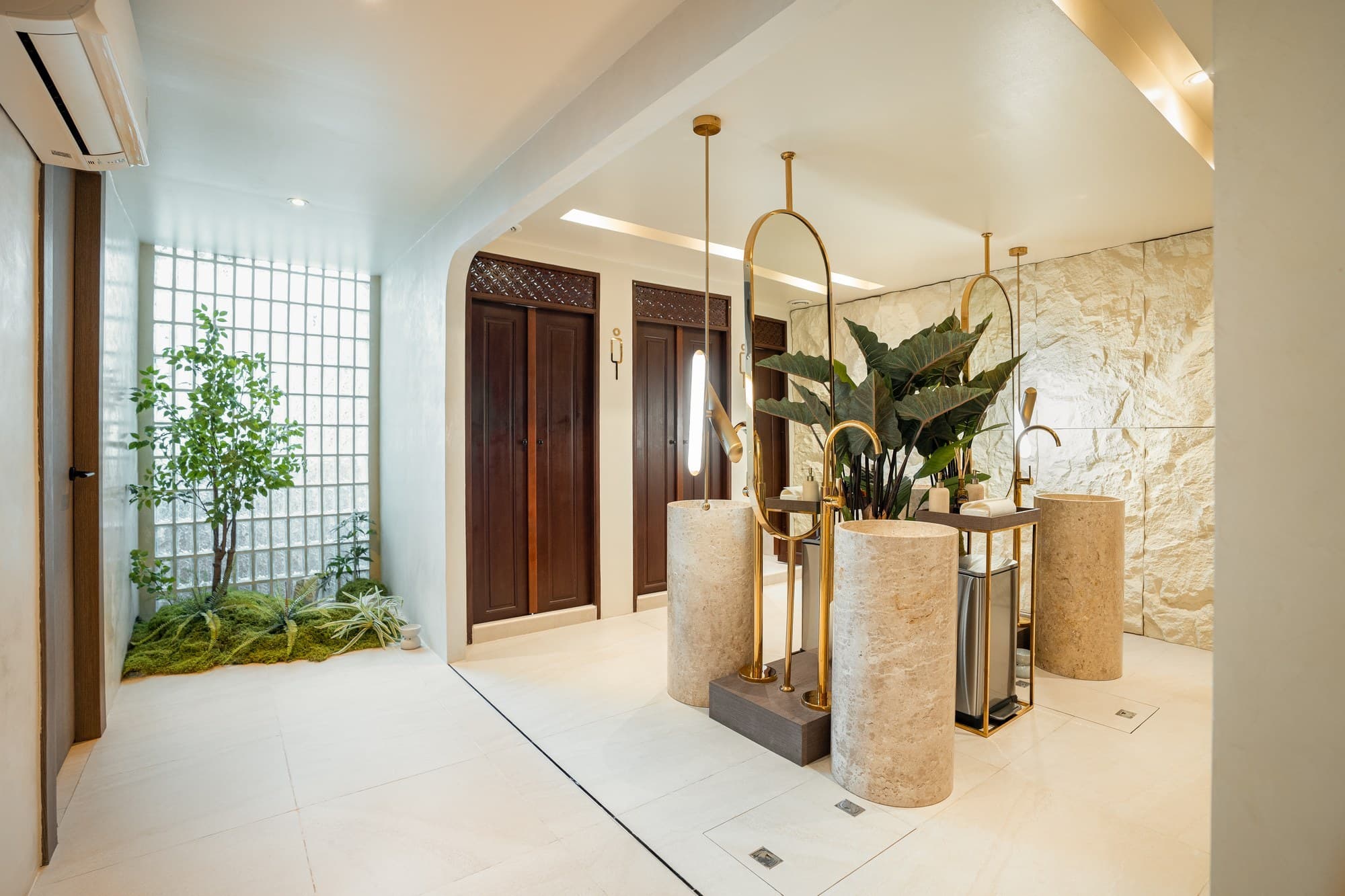 The spa entrance: stone basins, brass and a courtyard garden